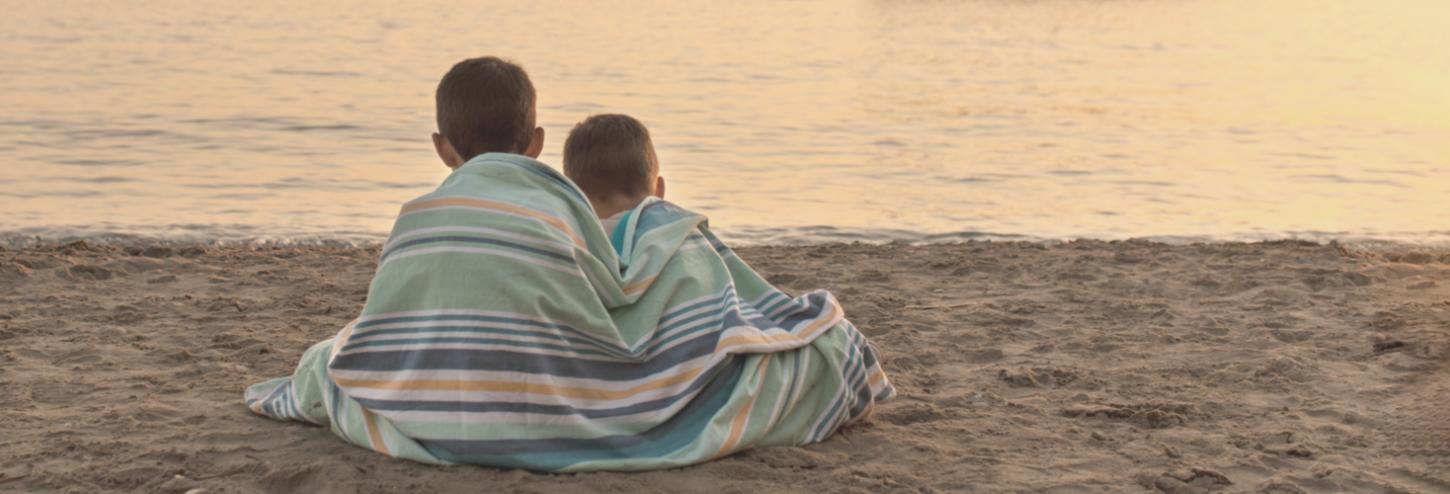 young brothers relax on the beach